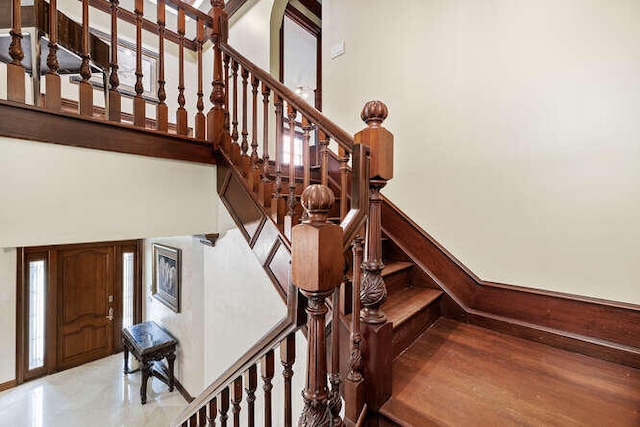 staircase featuring a high ceiling