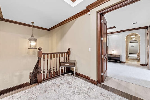 stairway featuring crown molding