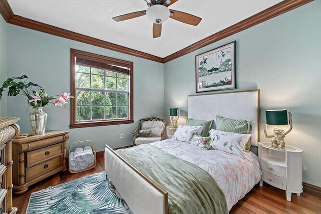 bedroom featuring crown molding, dark hardwood / wood-style floors, and ceiling fan