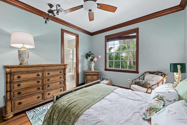 bedroom featuring connected bathroom, hardwood / wood-style floors, and crown molding