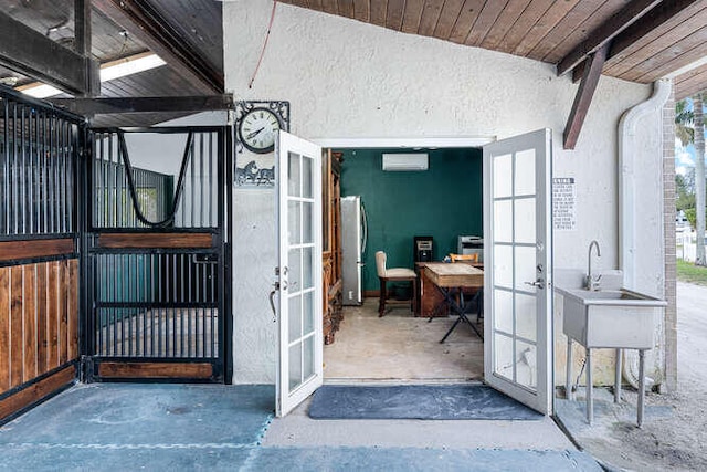 view of stable featuring a wall mounted AC and sink