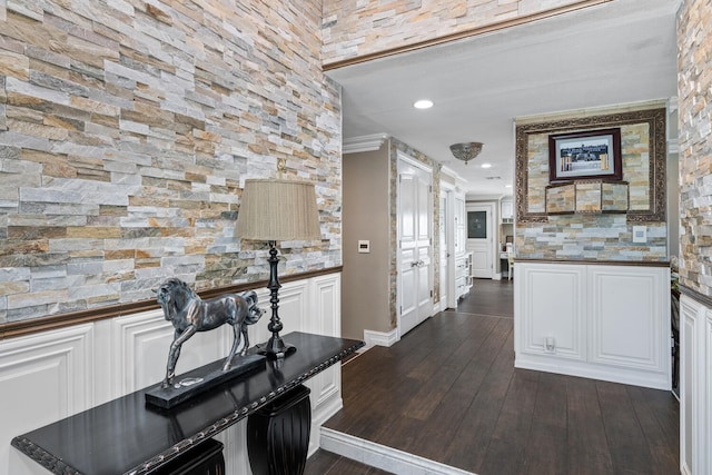 kitchen with white cabinetry, ornamental molding, and dark hardwood / wood-style floors