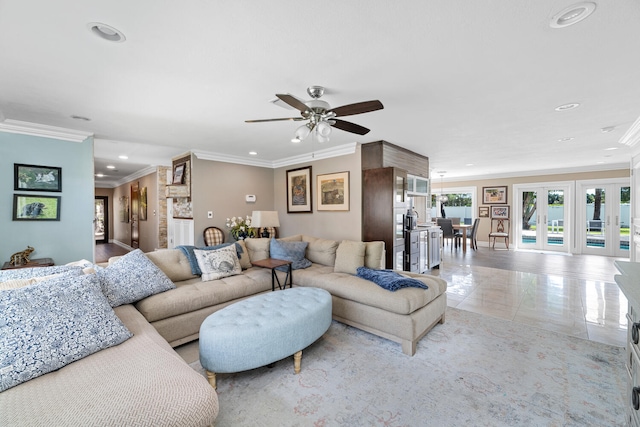 tiled living room with crown molding, french doors, and ceiling fan