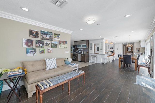 living room with crown molding and dark wood-type flooring