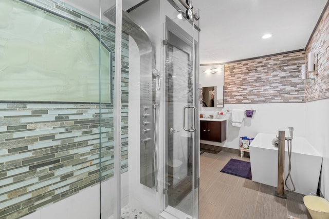 bathroom with vanity and shower with separate bathtub