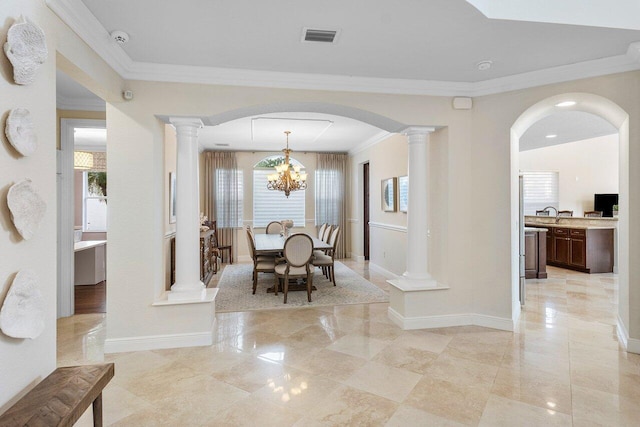 dining space featuring ornamental molding and a notable chandelier