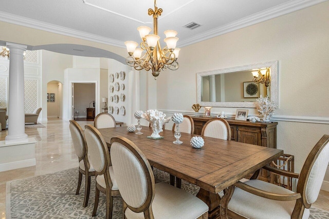 dining room with ornamental molding, decorative columns, and a chandelier