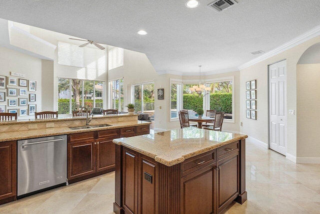 kitchen featuring dishwasher, hanging light fixtures, a center island, a textured ceiling, and sink