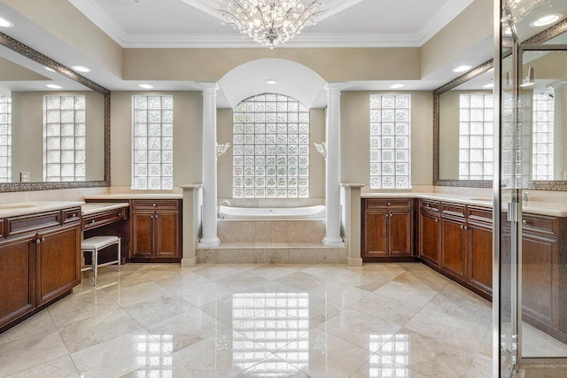 bathroom with a relaxing tiled tub, an inviting chandelier, decorative columns, and crown molding