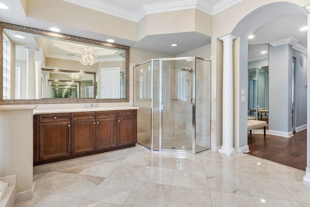 bathroom featuring an enclosed shower, a notable chandelier, crown molding, and vanity