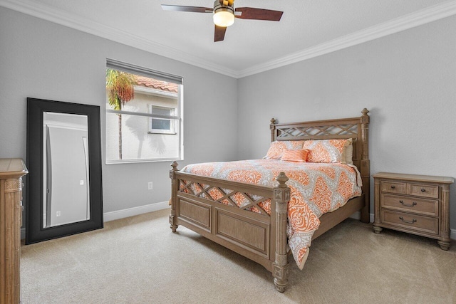 carpeted bedroom featuring ceiling fan and ornamental molding