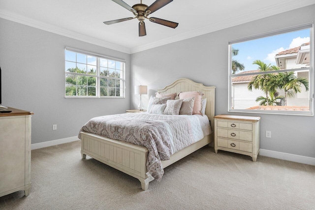 bedroom featuring ceiling fan, crown molding, and light colored carpet