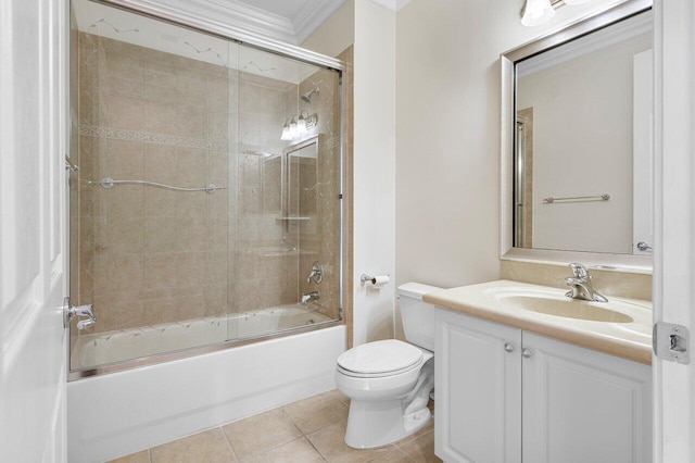 full bathroom featuring toilet, crown molding, vanity, tile patterned floors, and bath / shower combo with glass door