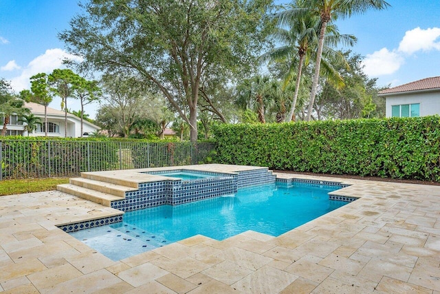 view of pool with a patio area and an in ground hot tub