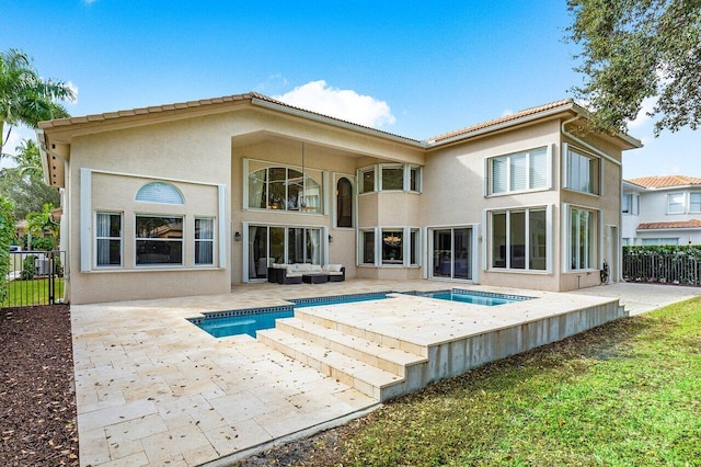 back of property featuring a patio area and outdoor lounge area