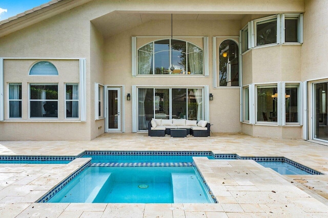 rear view of property with an outdoor hangout area, a patio area, and a swimming pool with hot tub