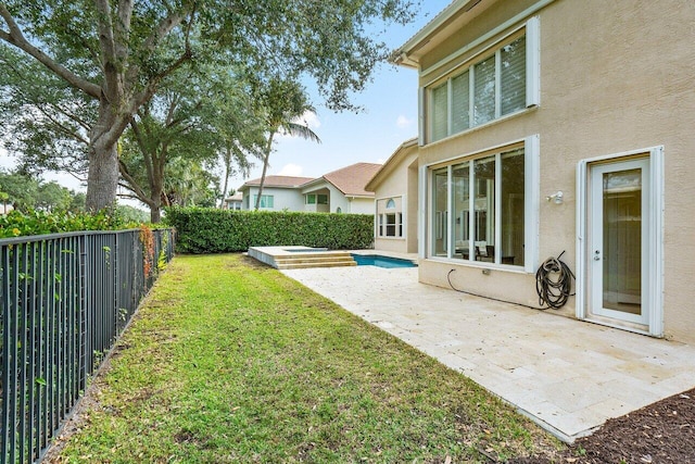 view of yard with a patio area and a jacuzzi