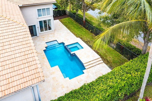 view of pool featuring an in ground hot tub and a patio