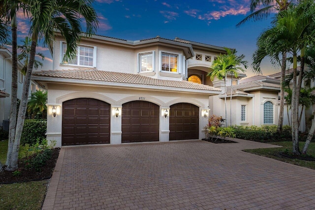 mediterranean / spanish-style home with a garage