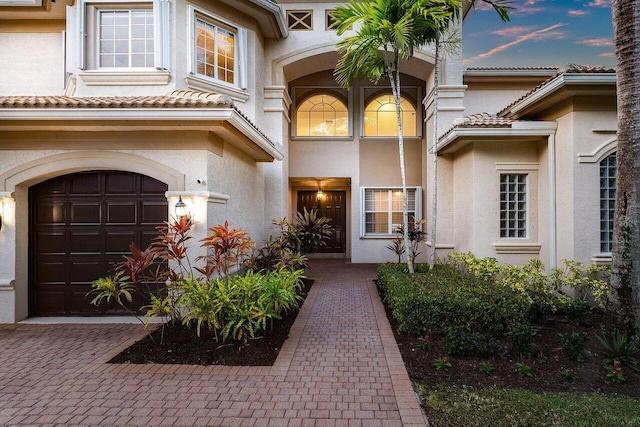 exterior entry at dusk with a garage