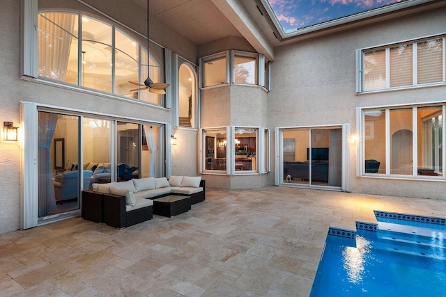 rear view of house featuring ceiling fan, an outdoor hangout area, and a patio