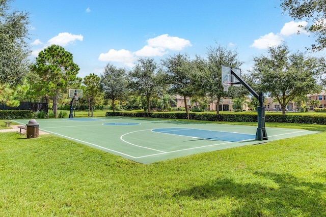 view of basketball court with a yard