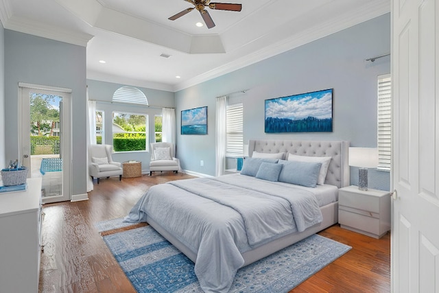 bedroom featuring wood-type flooring, crown molding, ceiling fan, a tray ceiling, and access to outside