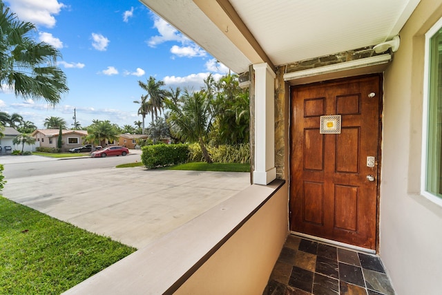 view of exterior entry with a porch