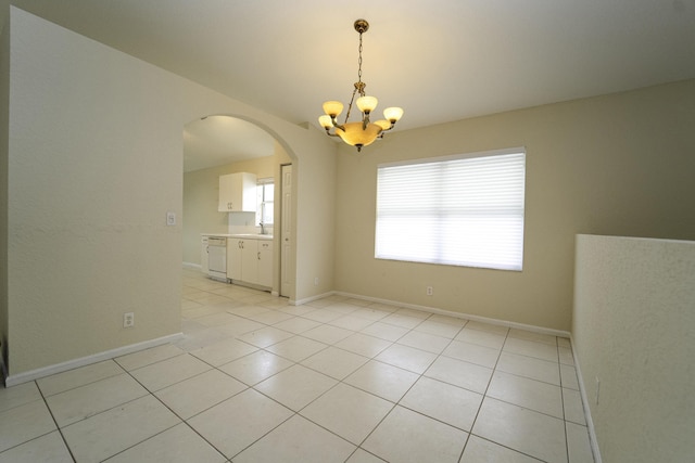 unfurnished room featuring a notable chandelier and light tile patterned floors