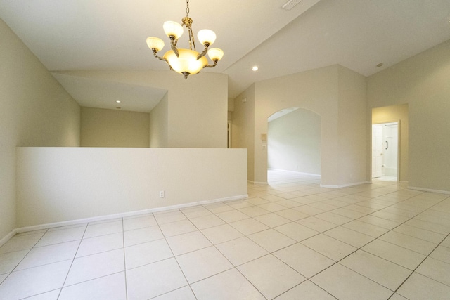 spare room featuring light tile patterned flooring and an inviting chandelier