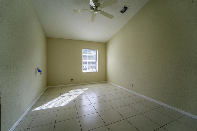 spare room featuring light tile patterned flooring, lofted ceiling, and ceiling fan