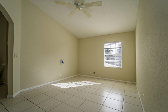 tiled spare room with ceiling fan and vaulted ceiling