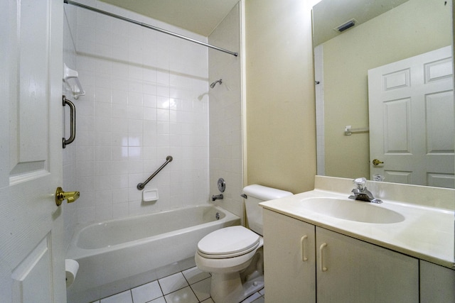 full bathroom featuring tiled shower / bath, vanity, toilet, and tile patterned flooring