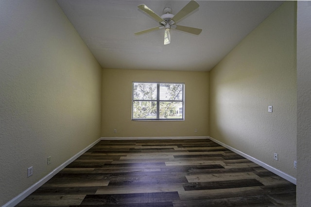 spare room with dark wood-type flooring, ceiling fan, and lofted ceiling