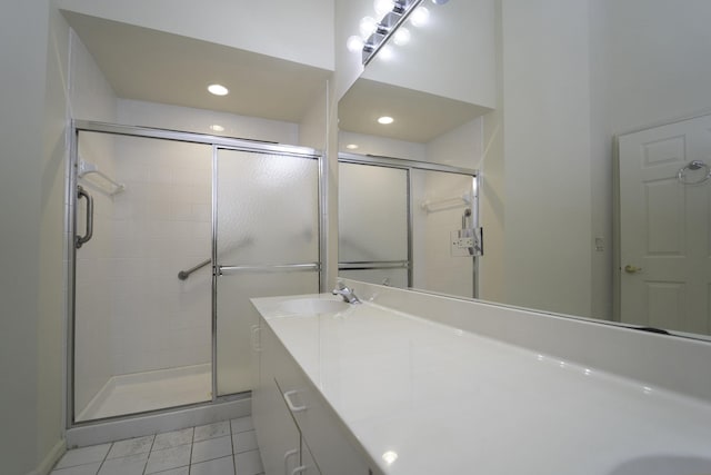 bathroom with vanity, an enclosed shower, and tile patterned floors