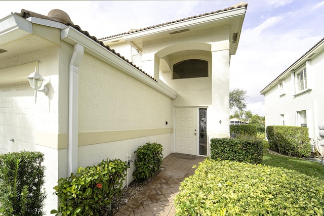 view of exterior entry with a garage