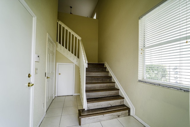 stairs with tile patterned flooring