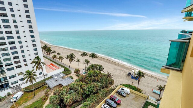 drone / aerial view featuring a water view and a beach view