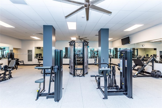 workout area featuring ceiling fan and a drop ceiling