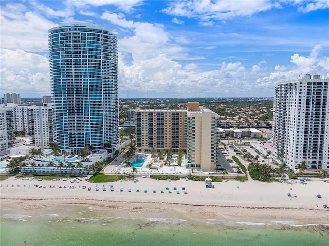 aerial view with a beach view, a water view, and a city view