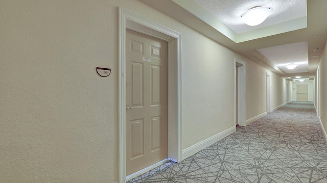 hallway featuring a textured ceiling