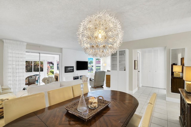 tiled dining area featuring a textured ceiling, a healthy amount of sunlight, and an inviting chandelier