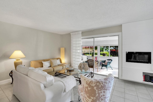 living room with a textured ceiling and light tile patterned floors