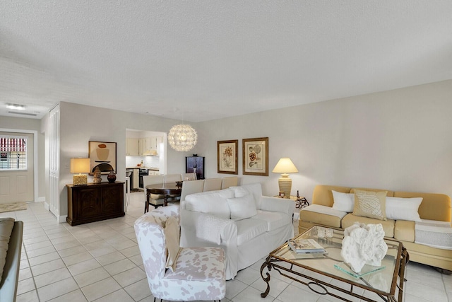 tiled living room featuring a notable chandelier and a textured ceiling