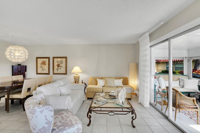 tiled living room featuring a textured ceiling and a notable chandelier