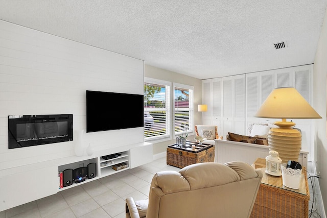 living room featuring a textured ceiling and tile patterned floors