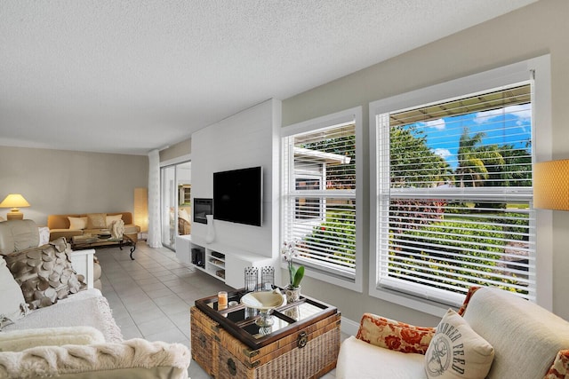 living room with light tile patterned floors and a textured ceiling