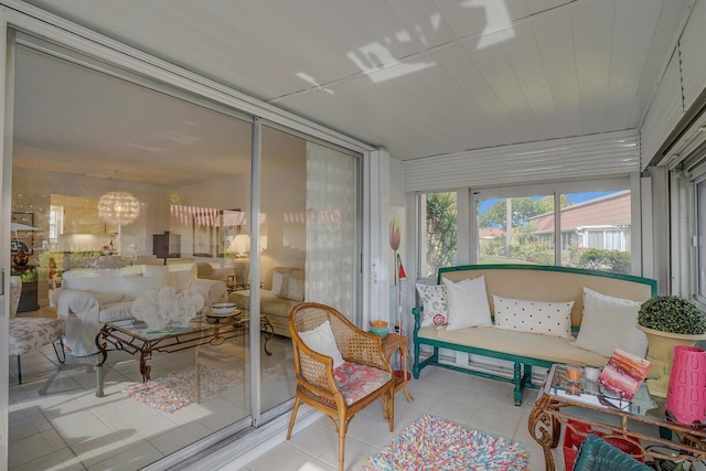 sunroom featuring an inviting chandelier