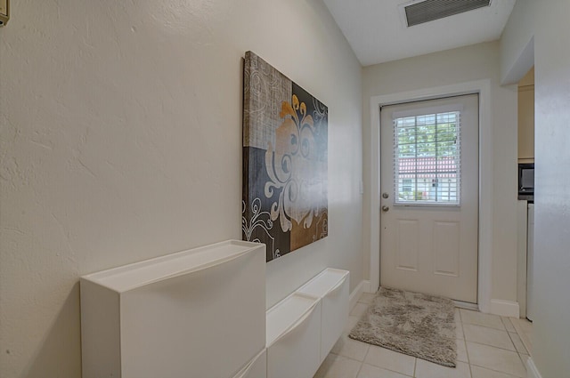 entryway with light tile patterned floors