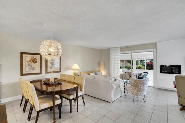 living room featuring a chandelier, light tile patterned flooring, and a textured ceiling